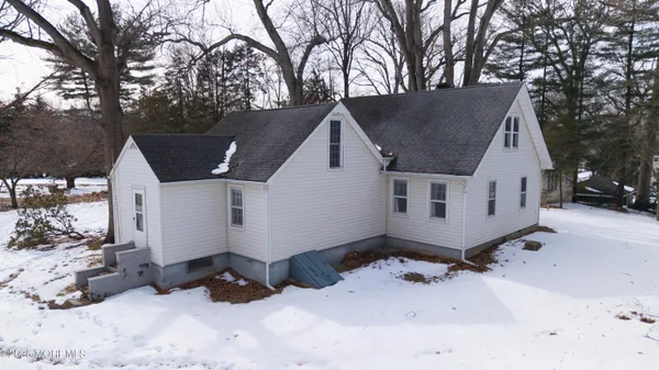 a view of a house with a yard covered in snow