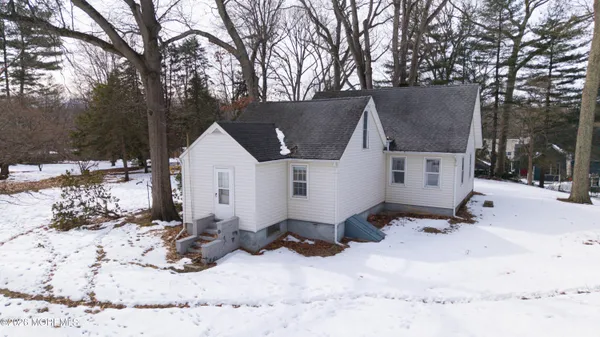 a view of house with a yard covered in snow