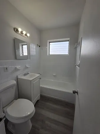 a bathroom with a toilet a sink and bathtub