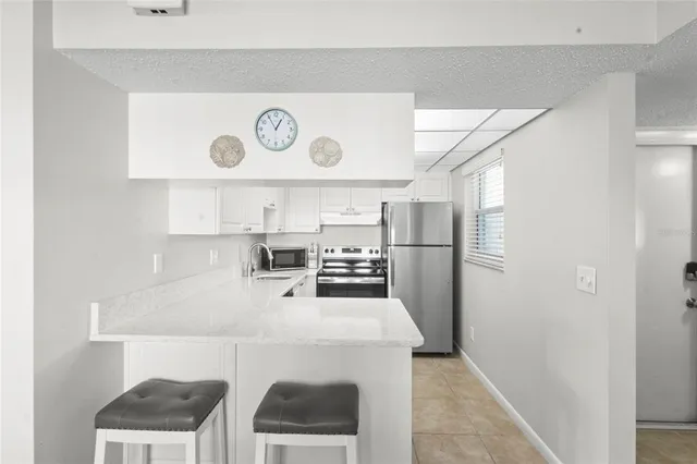 a kitchen with refrigerator and cabinets