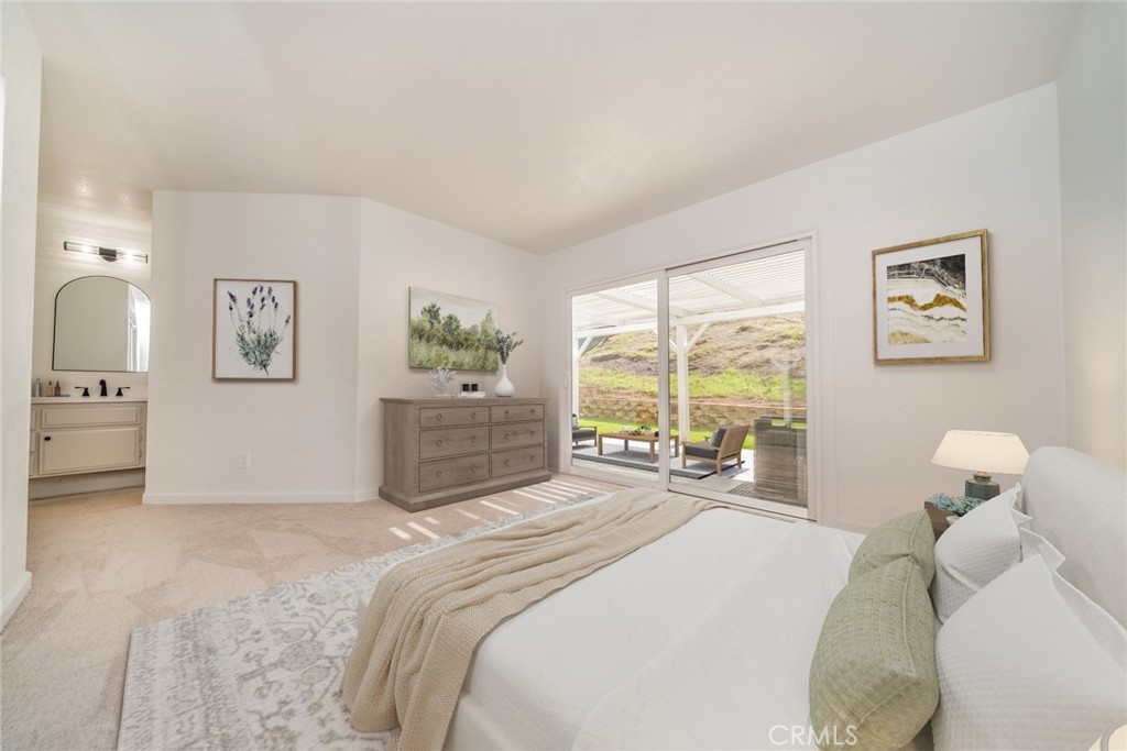 14721 Weeping Willow Lane Fontana, CA 92337 - Photo 14 of 25 a bedroom with a bed and glass windows