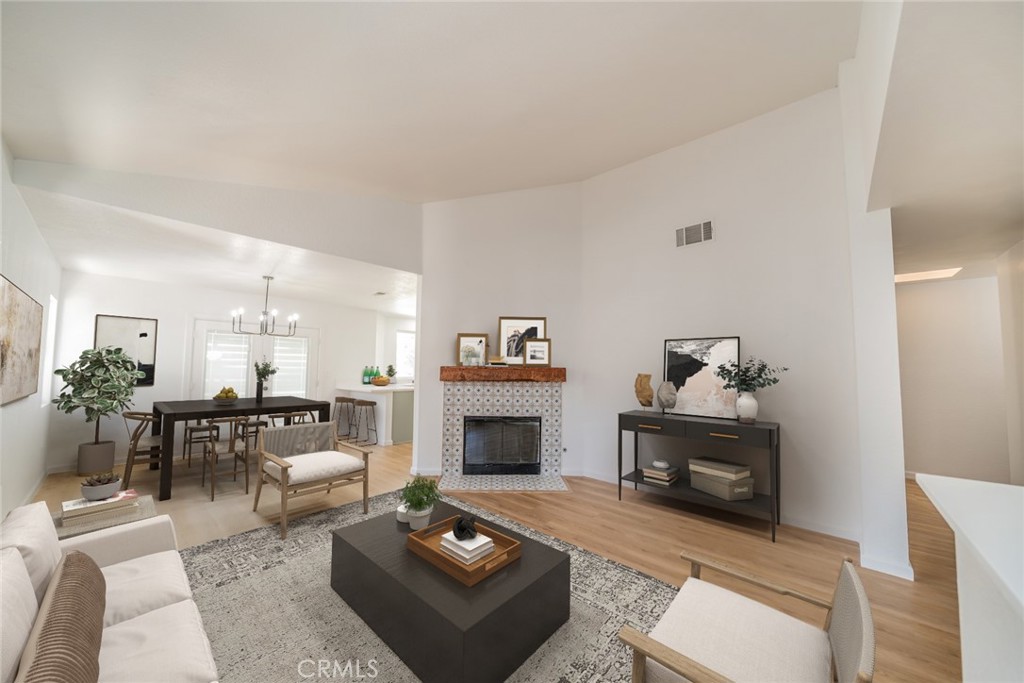 14721 Weeping Willow Lane Fontana, CA 92337 - Photo 3 of 25 a living room with furniture a rug and a fireplace