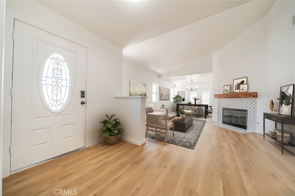 14721 Weeping Willow Lane Fontana, CA 92337 - Photo 4 of 25 a living room with furniture a fireplace and a potted plant