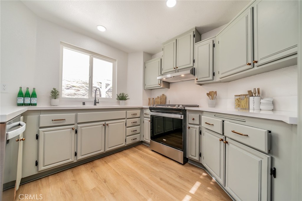 14721 Weeping Willow Lane Fontana, CA 92337 - Photo 7 of 25 a kitchen with cabinets appliances and a window