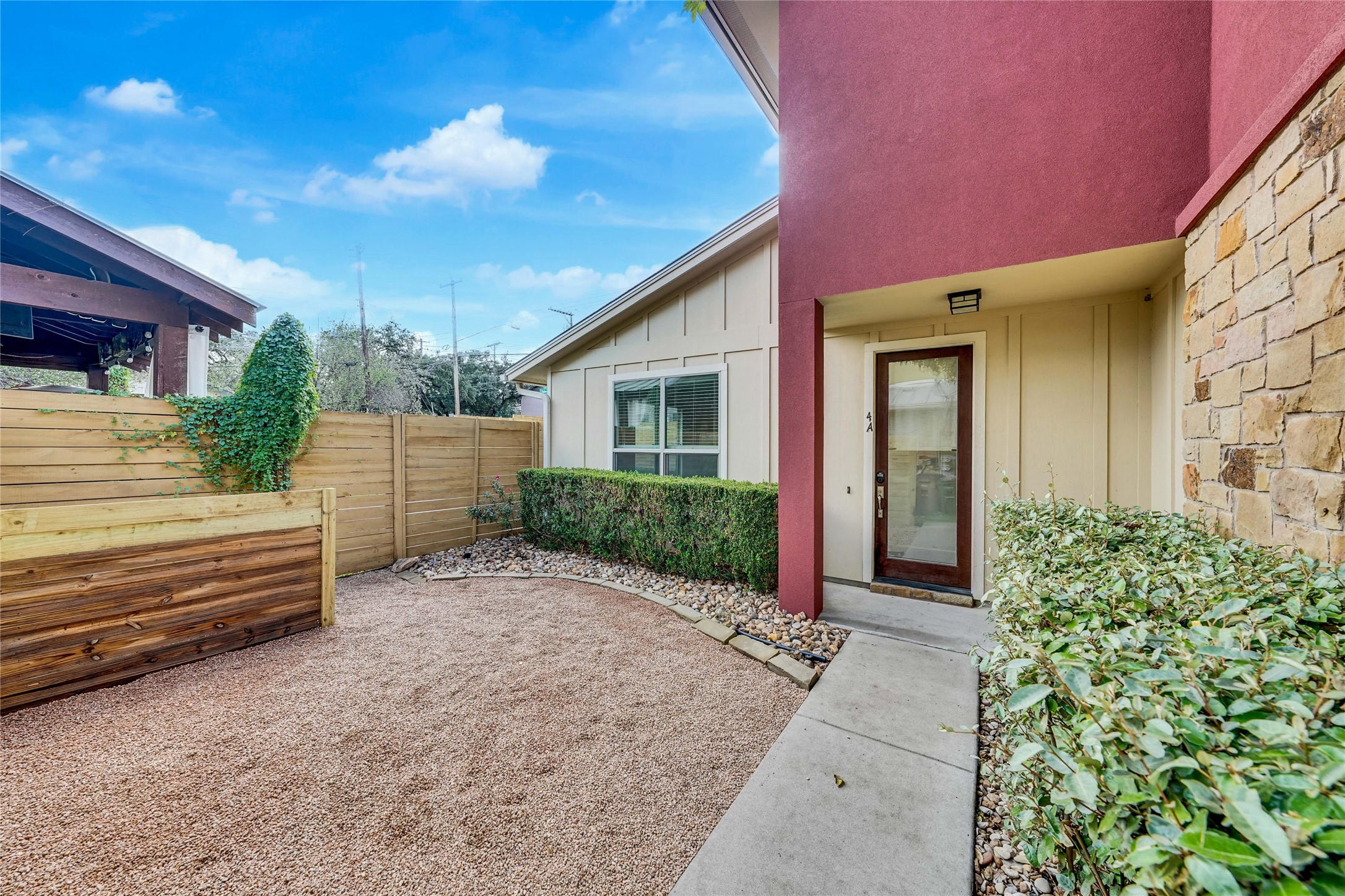 4124 Valley View Road, Unit 4A Austin, TX 78704 - Photo 7 of 37 A welcoming front entrance features a courtyard leading to an inviting modern entry.