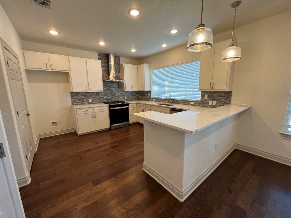 2105 Tiger Trail, Unit 502 Round Rock, TX 78664 - Photo 4 of 16 a kitchen with a stove a sink a refrigerator and a microwave