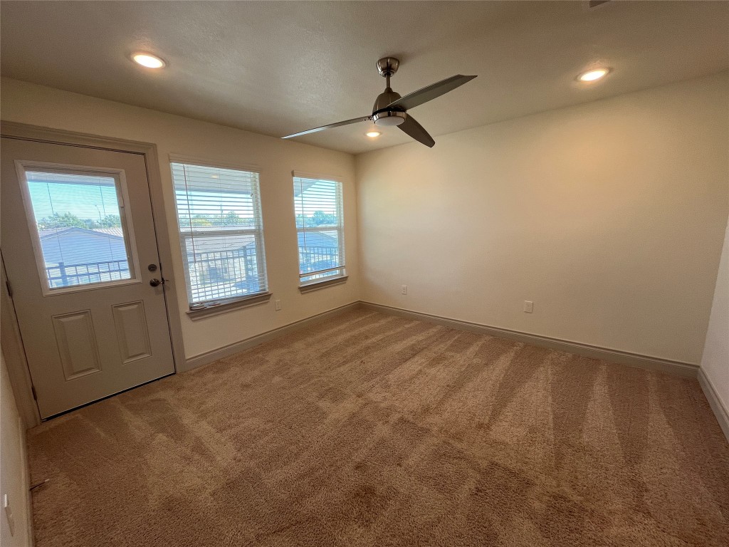2105 Tiger Trail, Unit 502 Round Rock, TX 78664 - Photo 5 of 16 an empty room with windows and ceiling fan