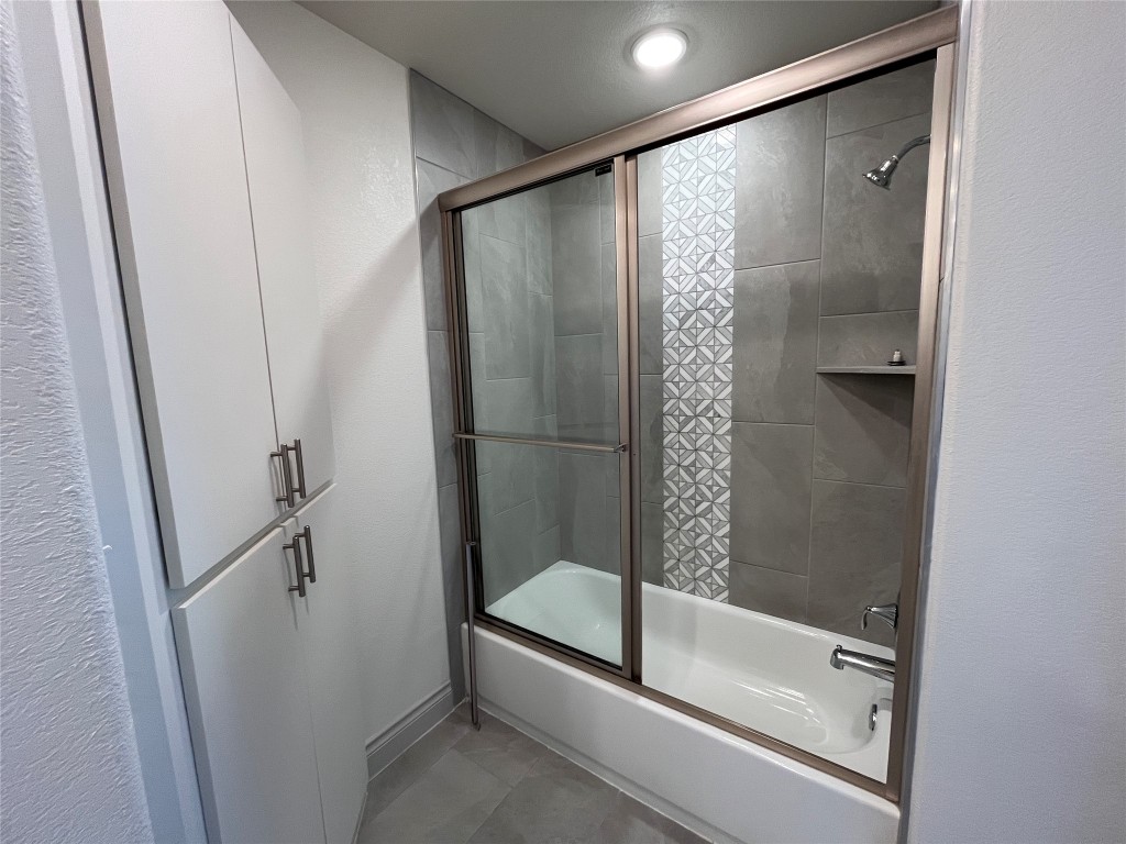 2105 Tiger Trail, Unit 502 Round Rock, TX 78664 - Photo 8 of 16 a bathroom with a glass shower door