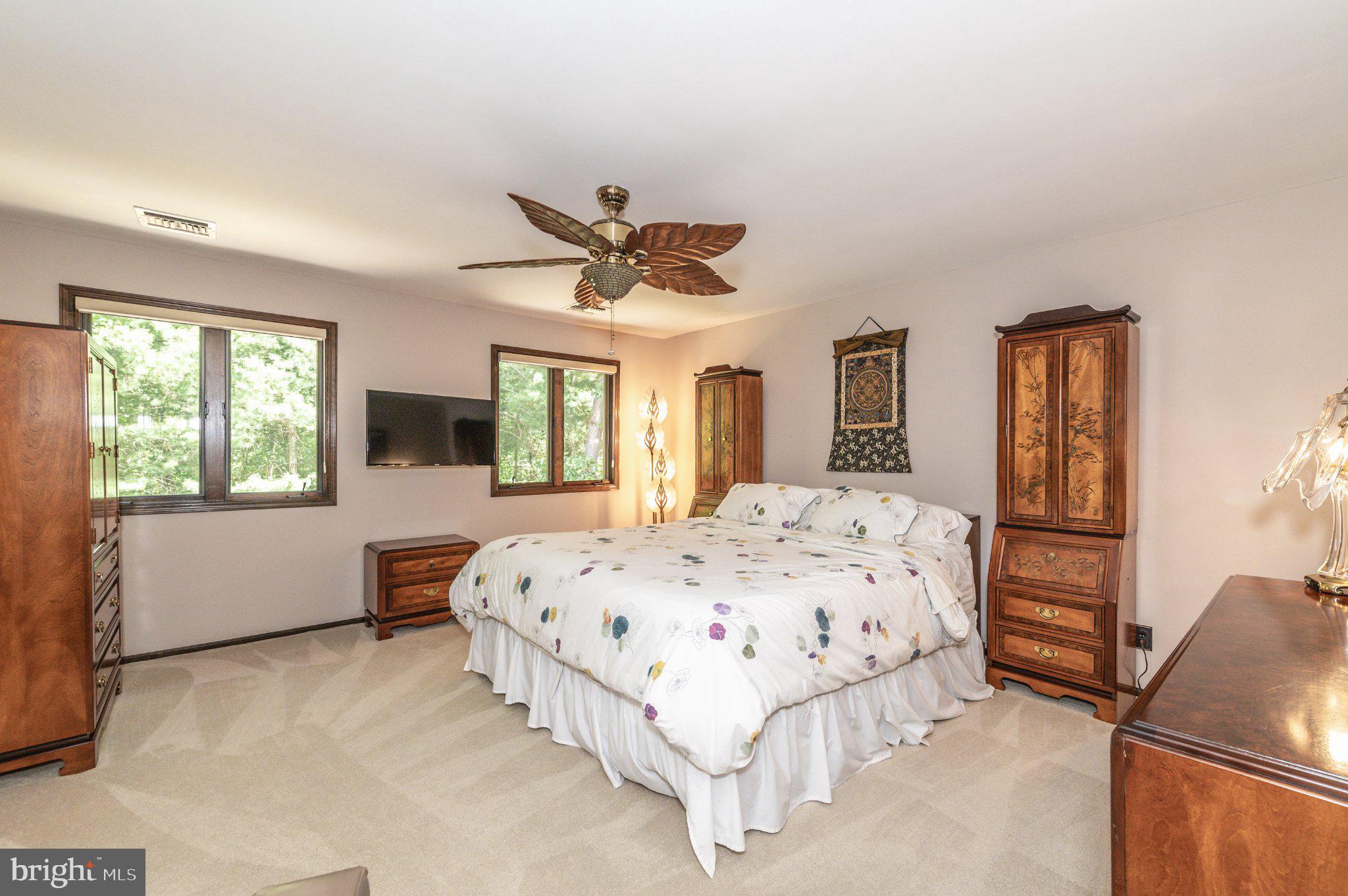 434 4th Street Atco, NJ 08004 - Photo 35 of 69 a spacious bedroom with a large bed a flat tv screen and a dresser