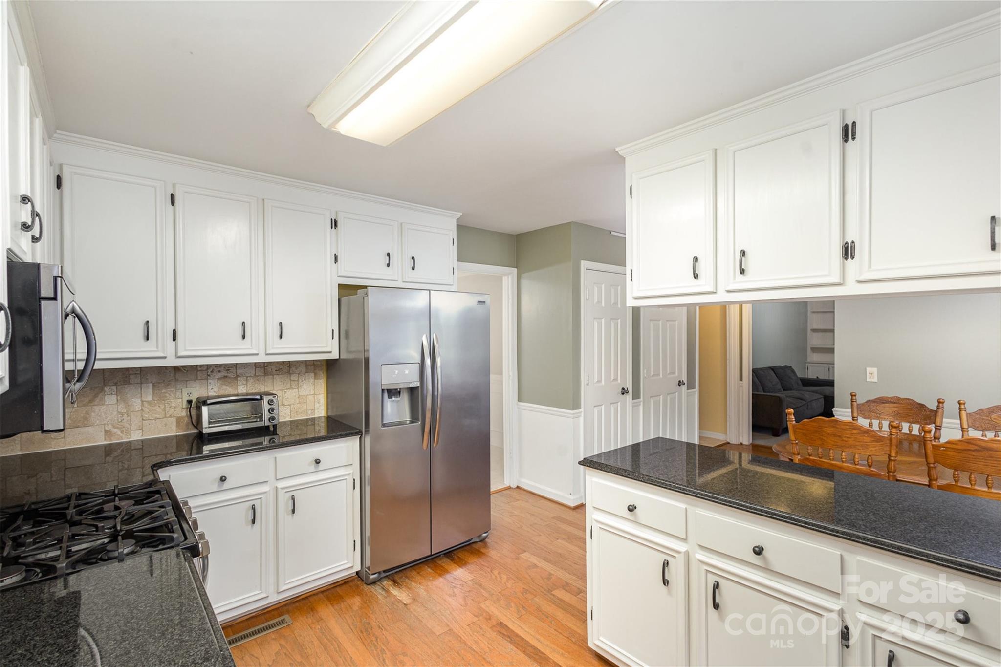 330 Regency Road Salisbury, NC 28147 - Photo 8 of 27 a kitchen with granite countertop white cabinets and stainless steel appliances