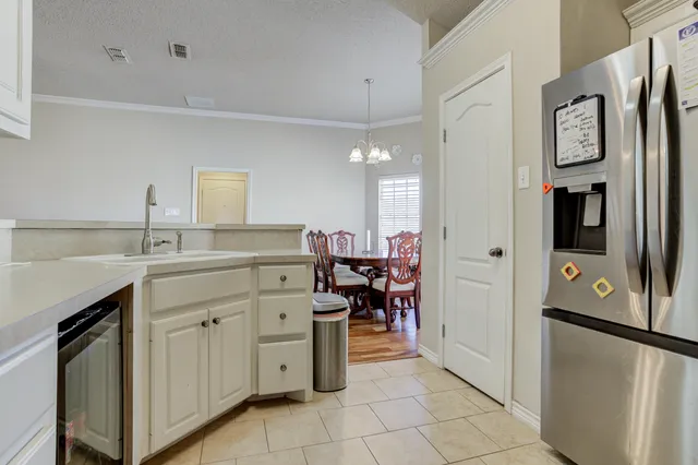 a kitchen with stainless steel appliances a refrigerator sink and cabinets