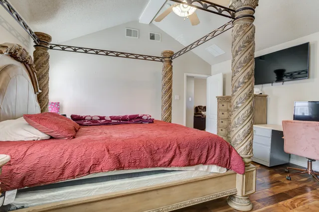 a bedroom with a bed and a flat screen tv