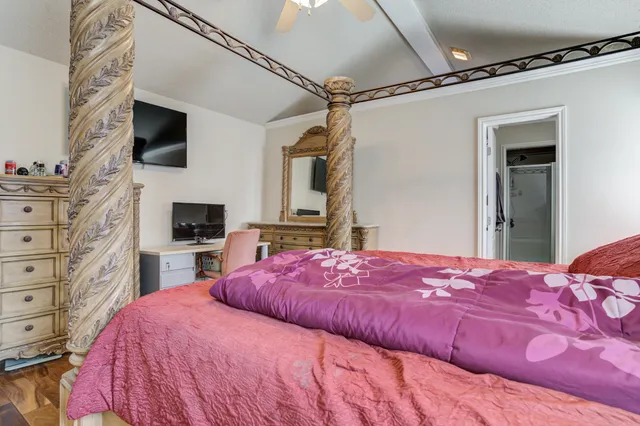 a bedroom with a bed and a flat screen tv