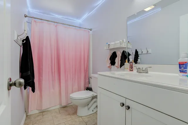 a bathroom with a sink a toilet and a mirror
