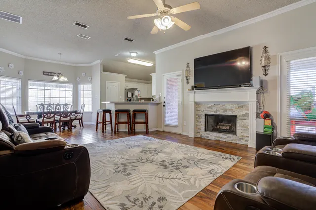 a living room with furniture fireplace and flat screen tv