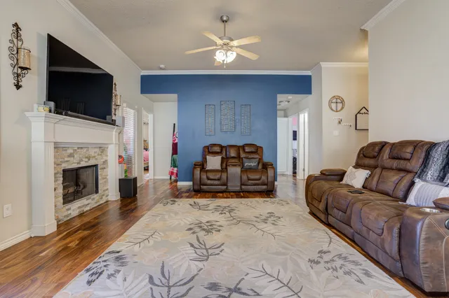 a living room with furniture a flat screen tv and a fireplace