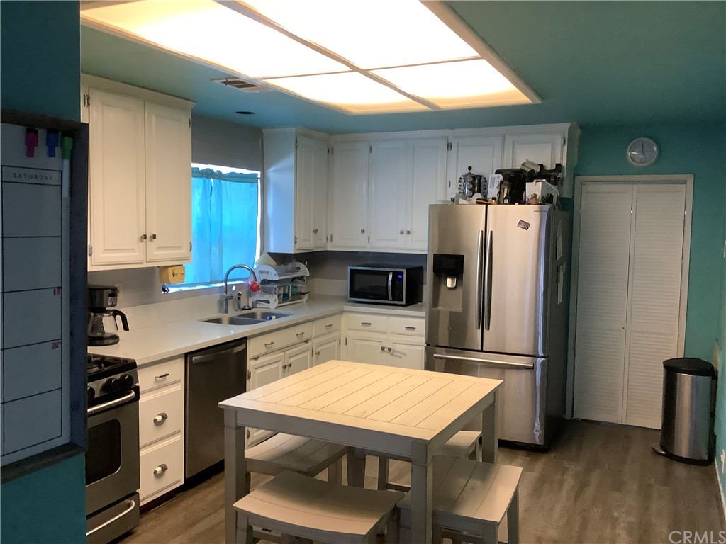 3643 Taft Street Riverside, CA 92503 - Photo 1 of 1 a kitchen with a refrigerator and a stove top oven