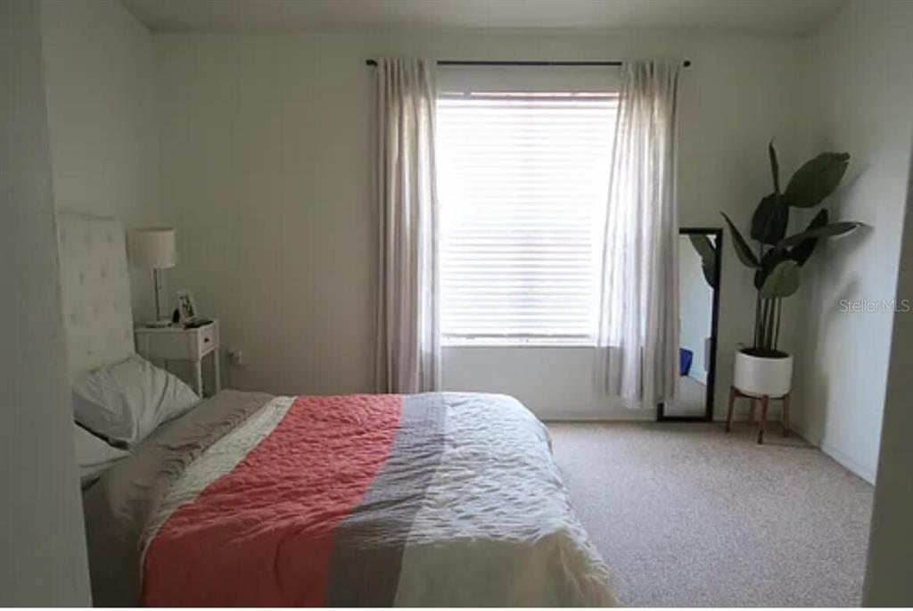 4415 Southwest 34th Street, Unit 308 Gainesville, FL 32608 - Photo 11 of 17 a bedroom with a bed and a window