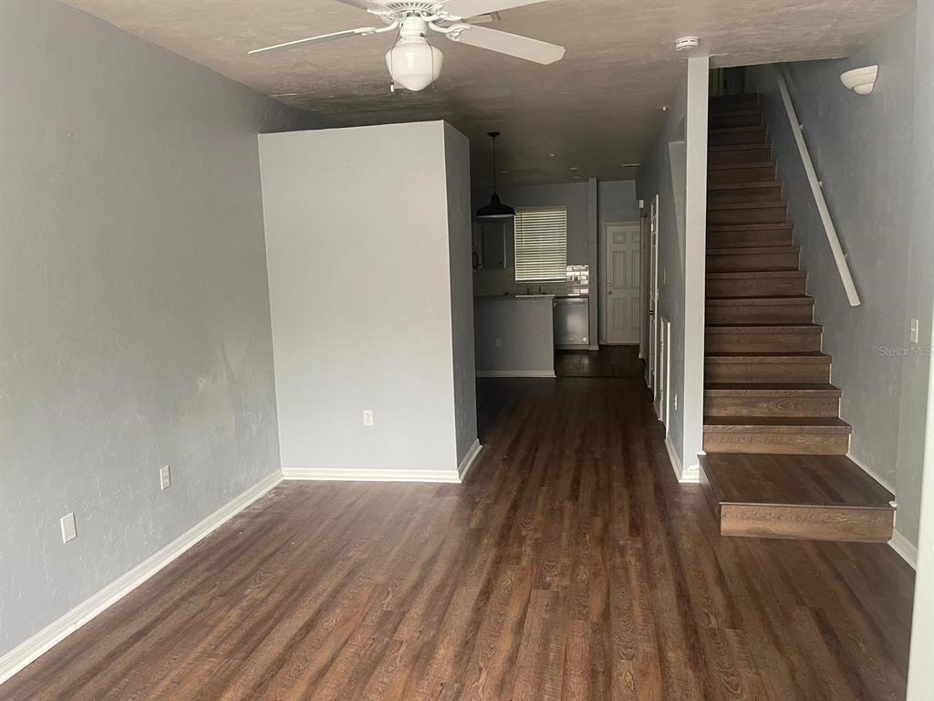 4415 Southwest 34th Street, Unit 308 Gainesville, FL 32608 - Photo 17 of 17 a view of a hallway with wooden floor and staircase
