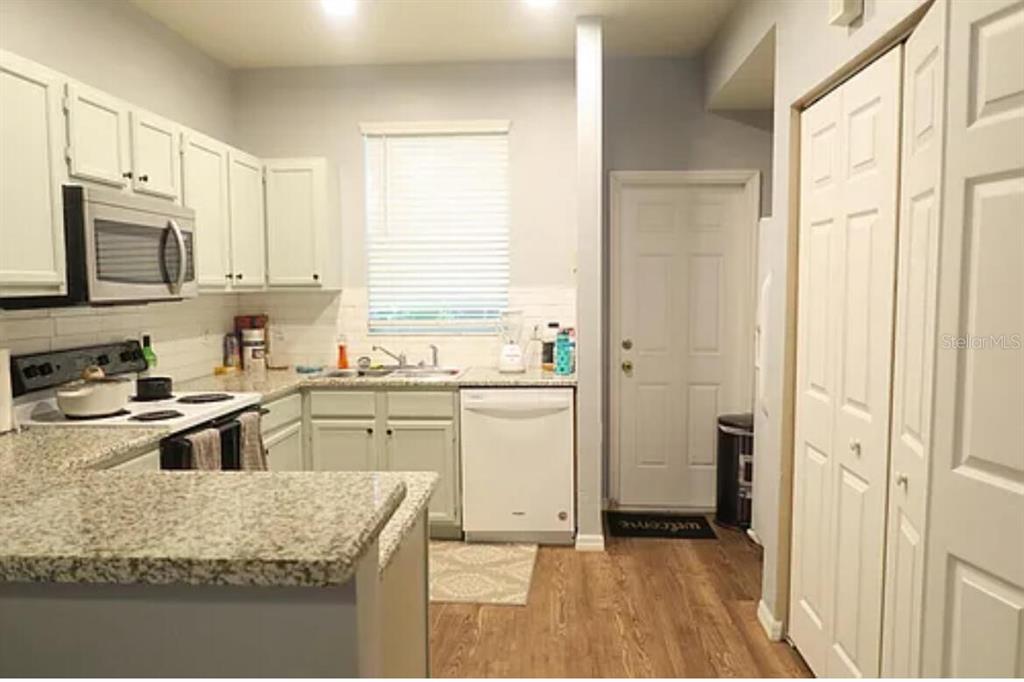 4415 Southwest 34th Street, Unit 308 Gainesville, FL 32608 - Photo 5 of 17 a kitchen with a sink stove and refrigerator