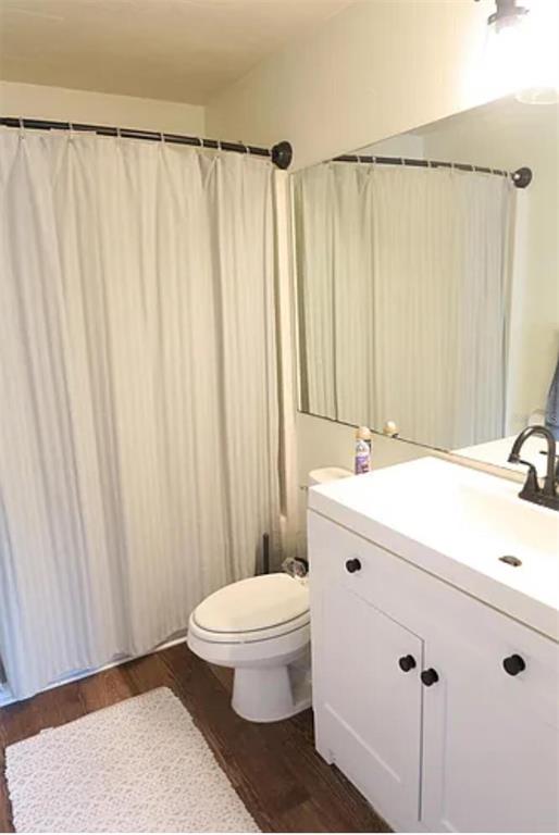 4415 Southwest 34th Street, Unit 308 Gainesville, FL 32608 - Photo 8 of 17 a bathroom with a sink a toilet and shower curtain