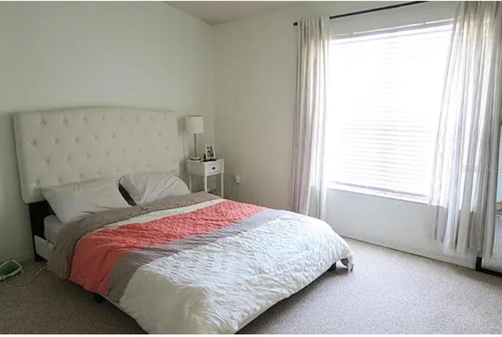 4415 Southwest 34th Street, Unit 308 Gainesville, FL 32608 - Photo 10 of 17 a bedroom with a bed and a window