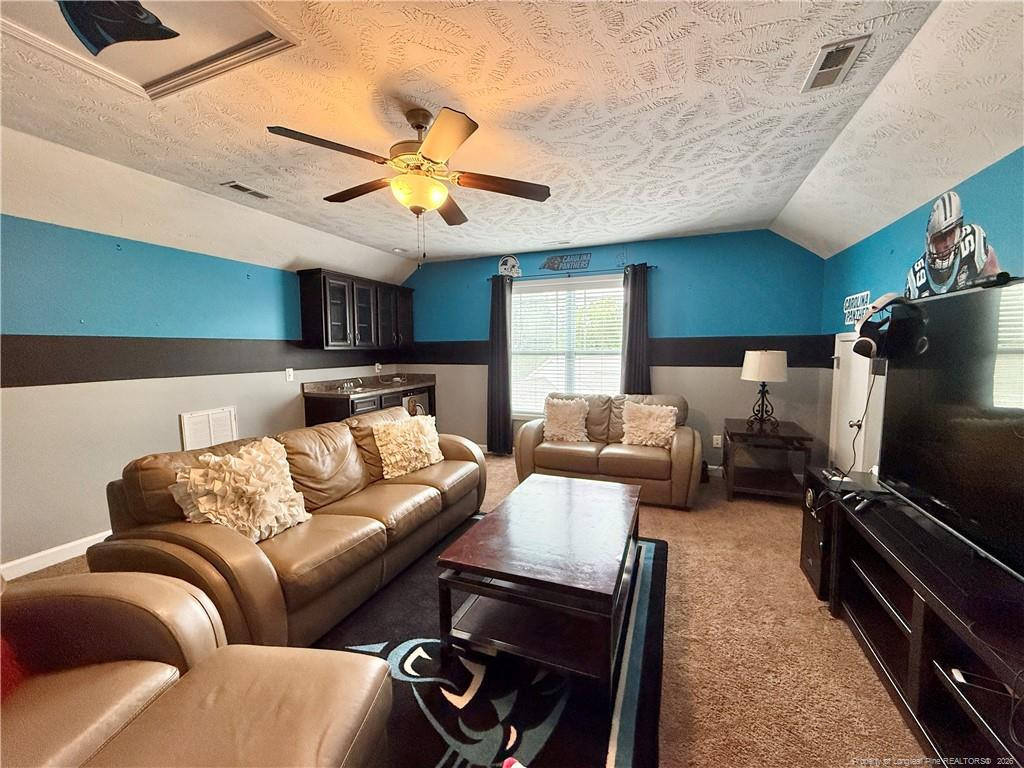 35 Ambrose Point Cameron, NC 28326 - Photo 26 of 31 a living room with furniture and a flat screen tv
