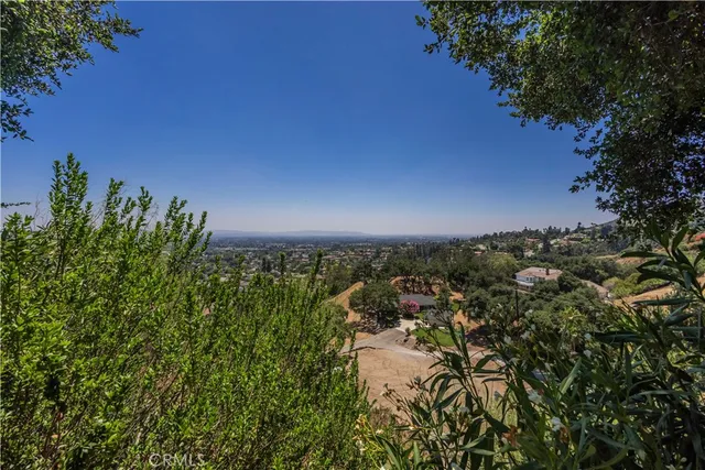 a view of a dry yard with wooden fence
