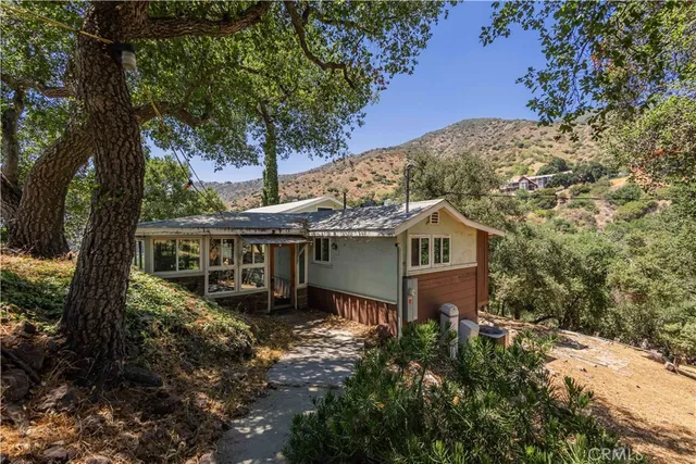 a backyard of a house with table and chairs