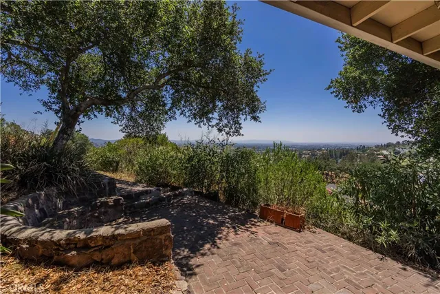 a view of a a dining room with furniture window and wooden floor