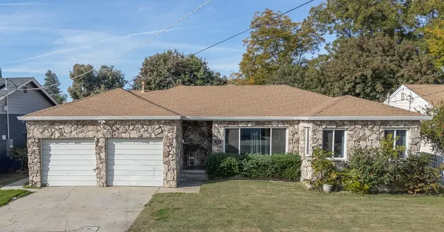a front view of a house with a garden