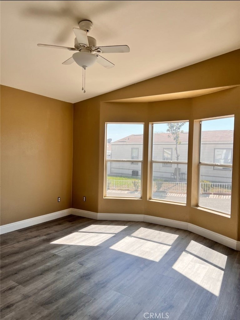 3700 Quartz Canyon Road, Unit 21 Jurupa Valley, CA 92509 - Photo 6 of 11 a view of an empty room with a window and wooden floor