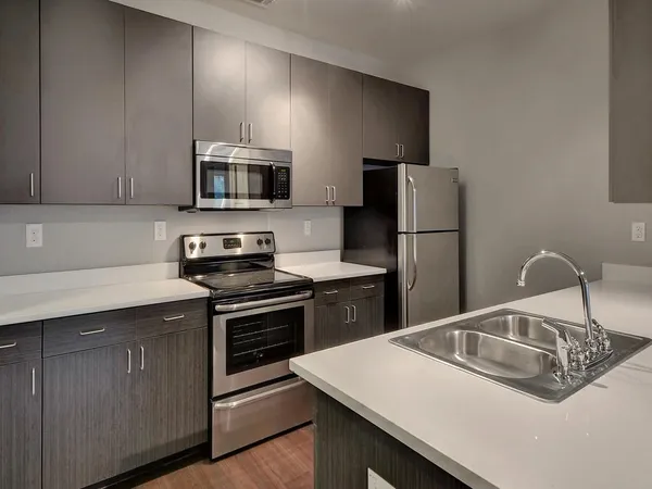 a kitchen with a sink a stove and refrigerator