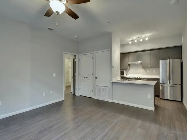 a kitchen with stainless steel appliances a refrigerator and a stove top oven