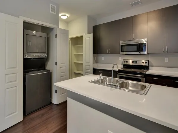 a kitchen that has a sink and a stove top oven