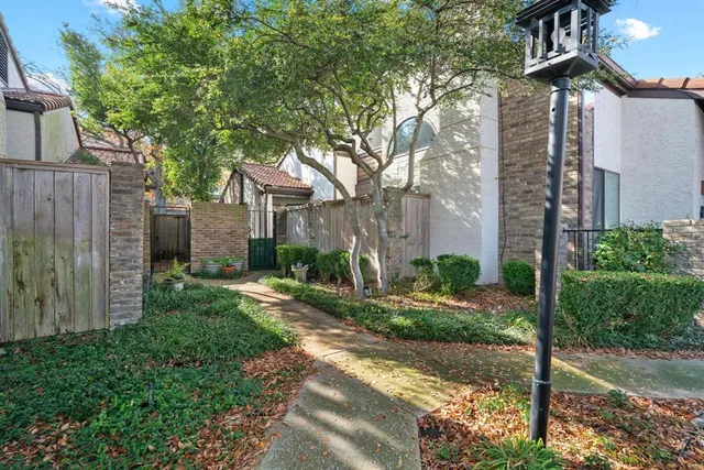 a pathway of a house with a yard