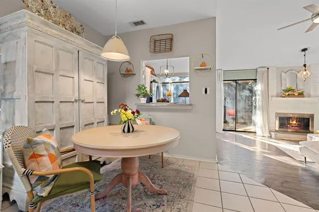 a view of a dining room with furniture and chandelier