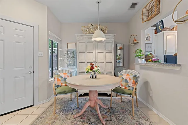 a living room with furniture a fireplace and a chandelier