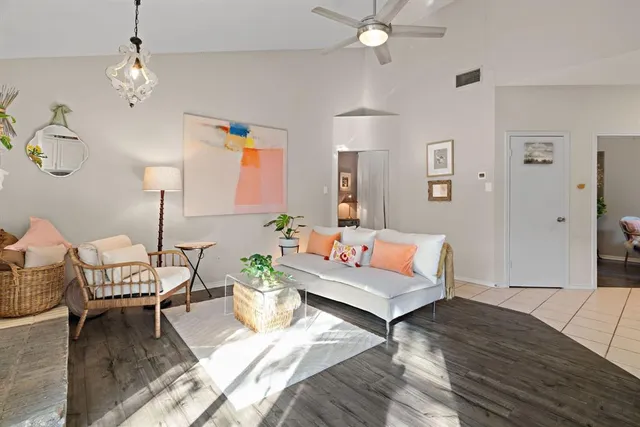a living room with furniture and a chandelier