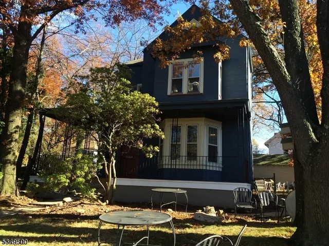 a front view of a house with trees