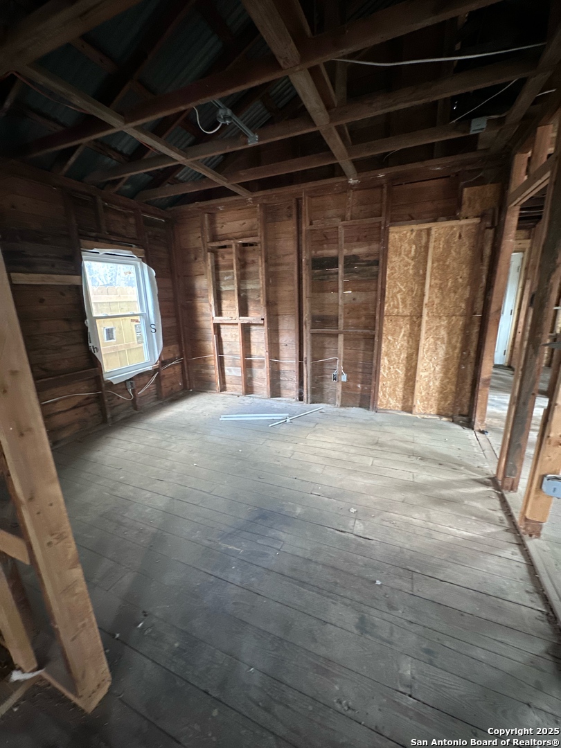 710 5th Street Natalia, TX 78059 - Photo 11 of 14 a view of an empty room with a fireplace and a window