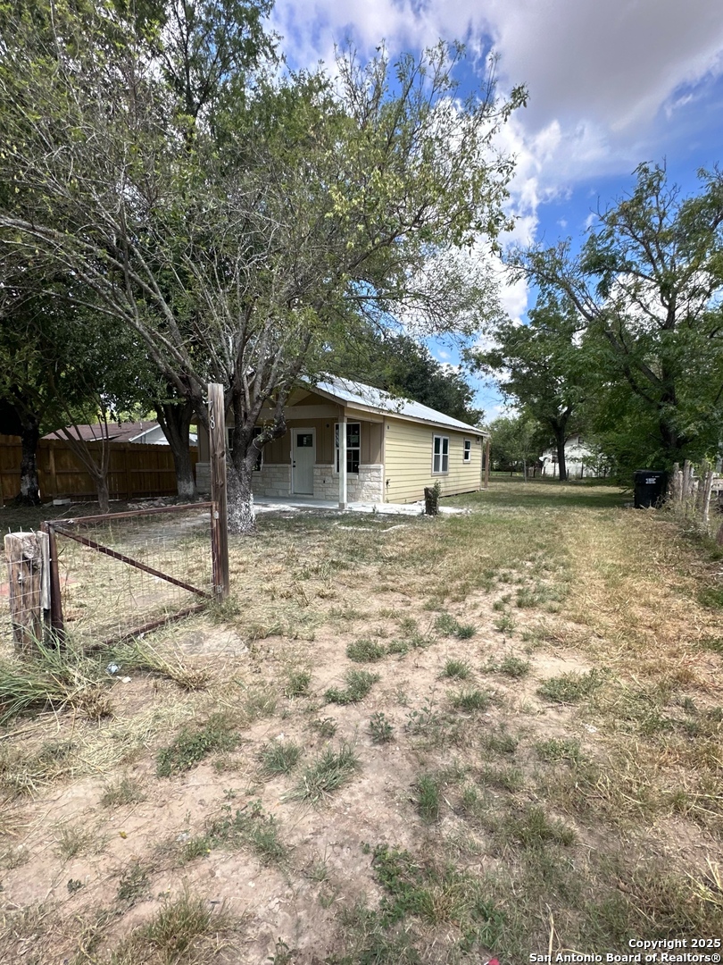 710 5th Street Natalia, TX 78059 - Photo 3 of 14 a backyard of a house with lots of green space