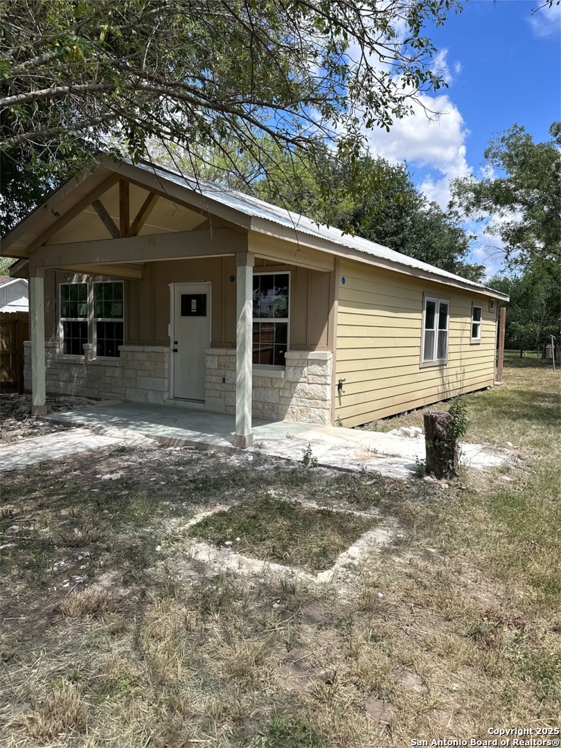 710 5th Street Natalia, TX 78059 - Photo 5 of 14 a front view of a house with a yard
