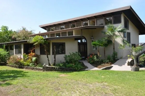 a front view of house with yard and green space