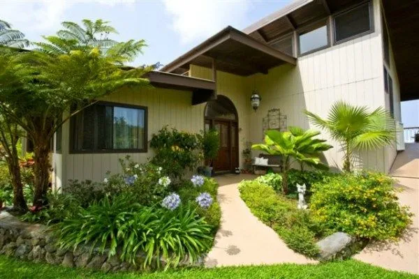 a front view of a house with garden