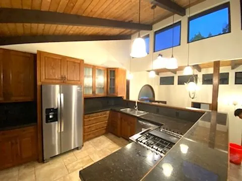 a kitchen with granite countertop a stove and refrigerator