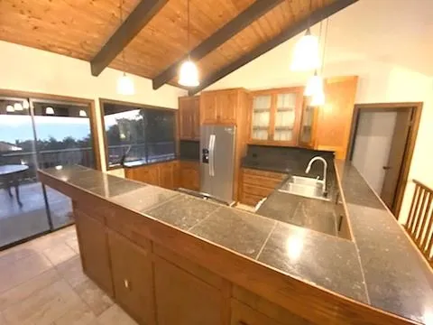 a view of a kitchen with a sink and wooden floor