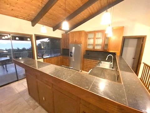 81-6315 Hawaiʻi Belt Road Captain Cook, HI 96750 - Photo 9 of 13 a view of a kitchen with a sink and wooden floor