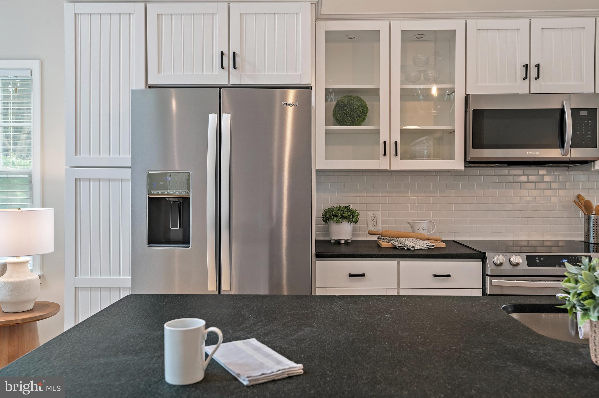 129 Gibson Road Annapolis, MD 21401 - Photo 12 of 50 a kitchen with stainless steel appliances granite countertop a refrigerator and a stove top oven
