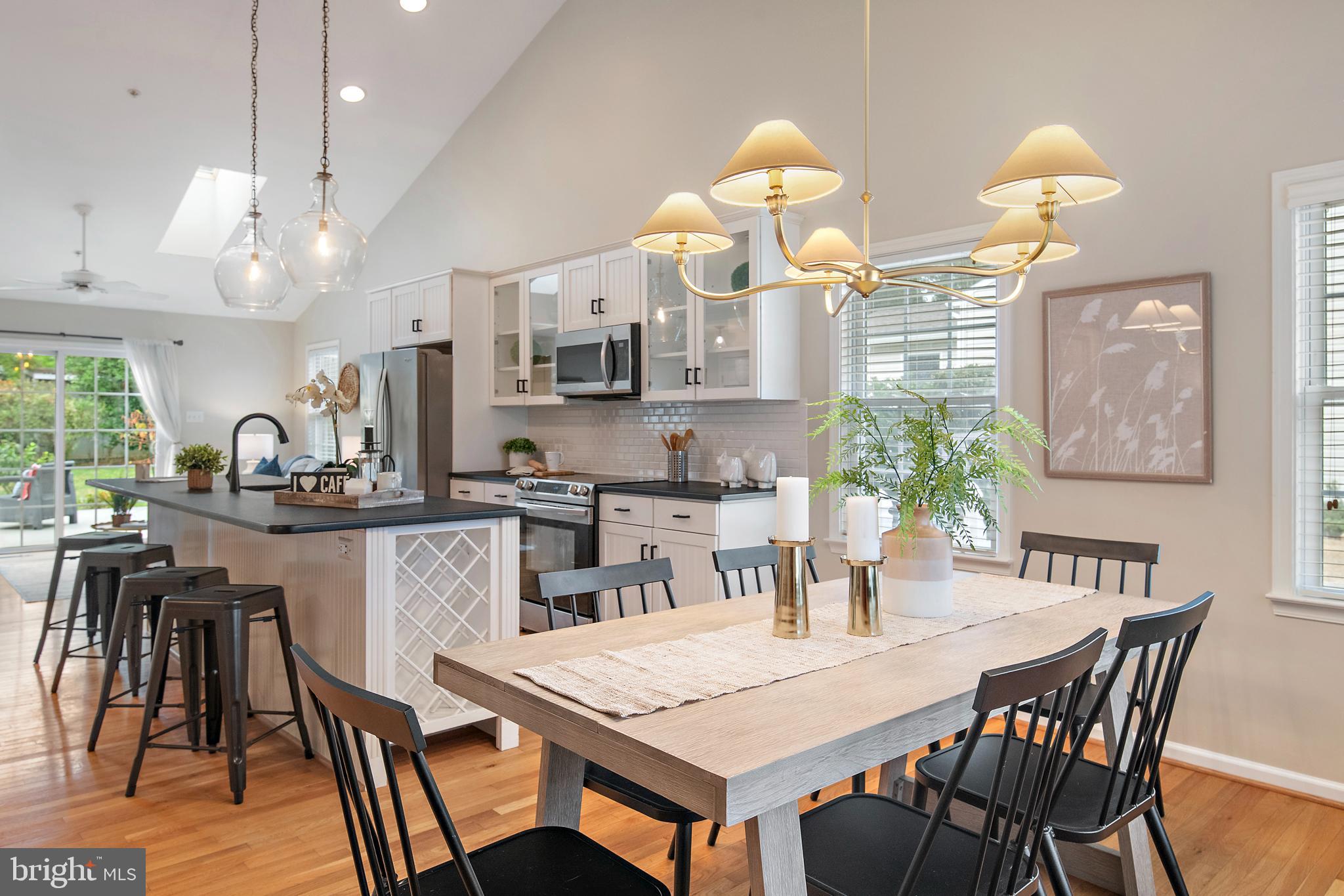 129 Gibson Road Annapolis, MD 21401 - Photo 14 of 50 a kitchen with a dining table chairs and microwave